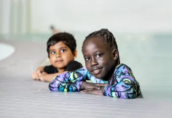 Two Children Learning to Swim