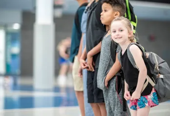 : A group of kids standing at the Y. 