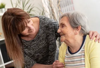 [image] Woman caring for elderly parent