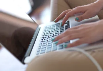 Fingers on a laptop keyboard