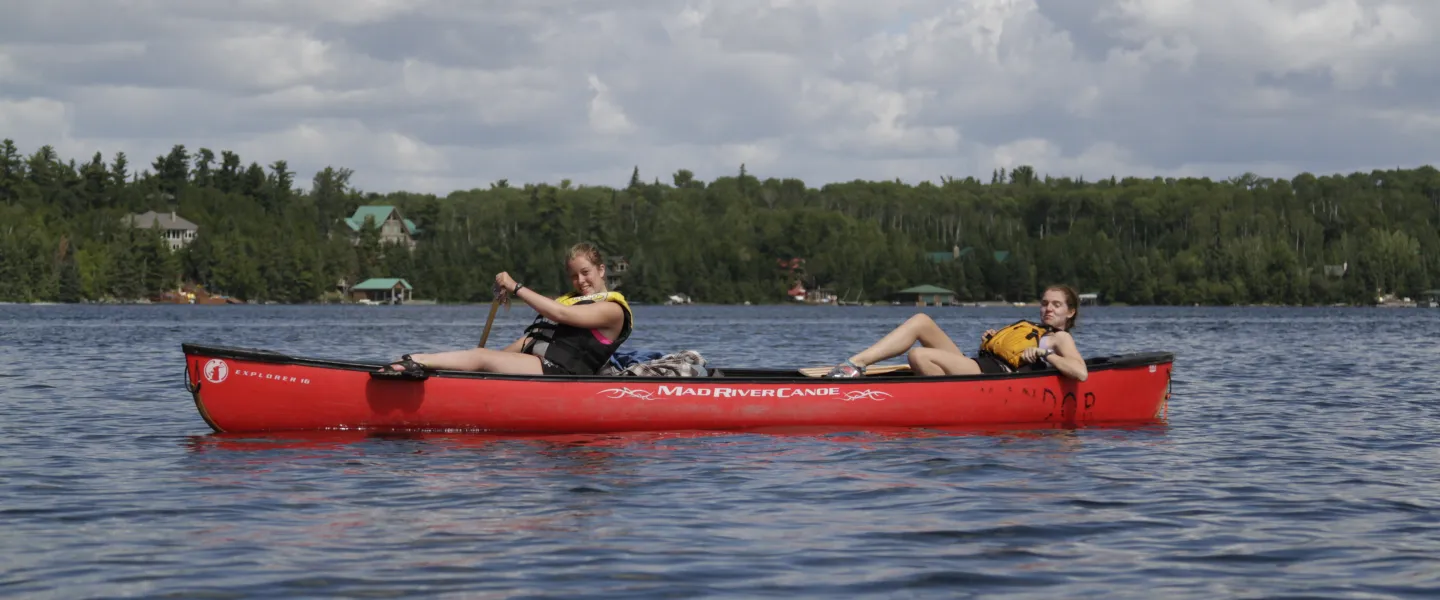 older teens in a canoe on the water