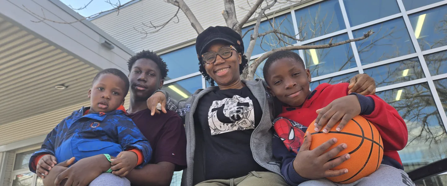 Olu and family sitting outside the South Y