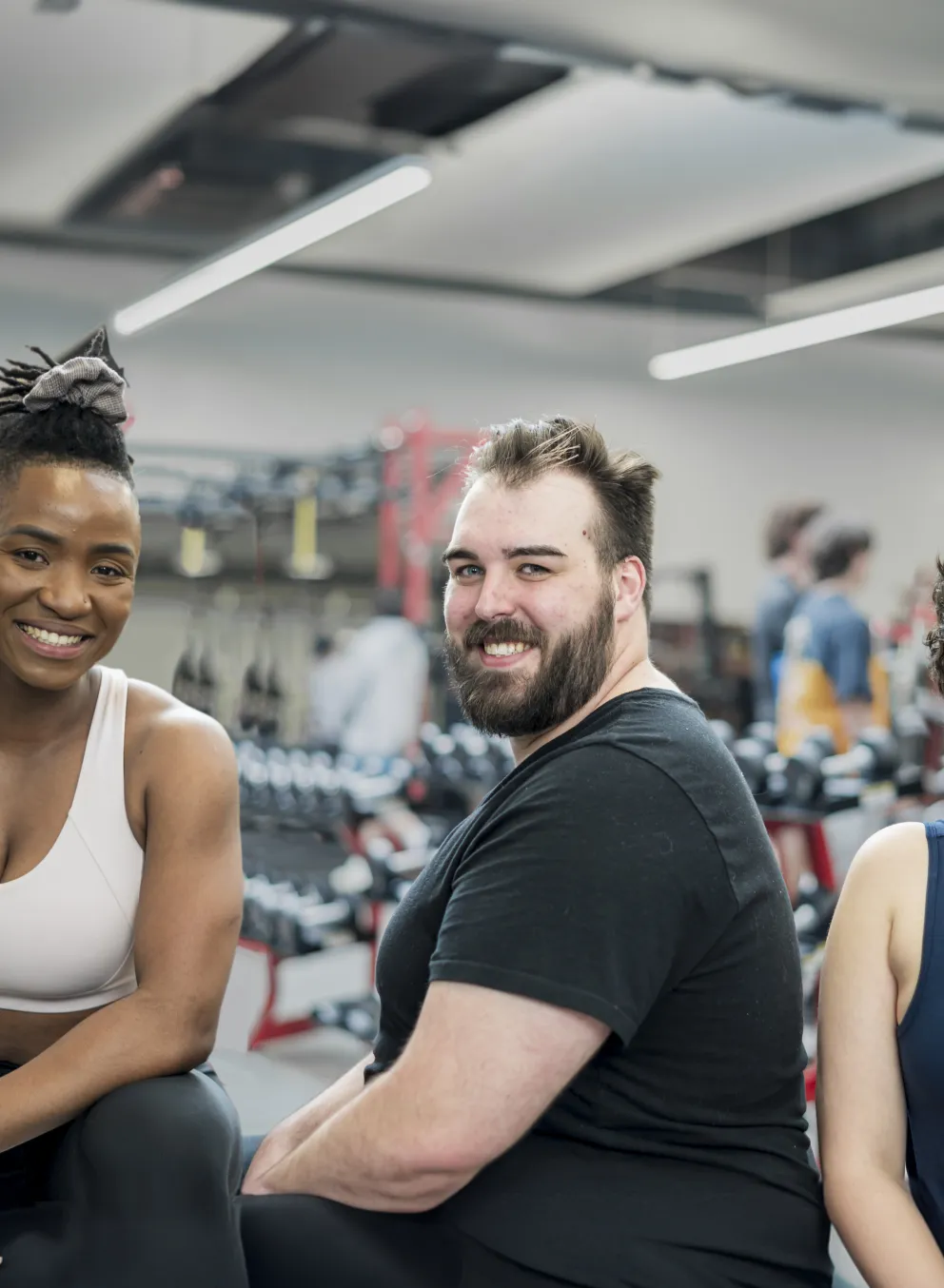 [Image] 3 smiling people in fitness centre