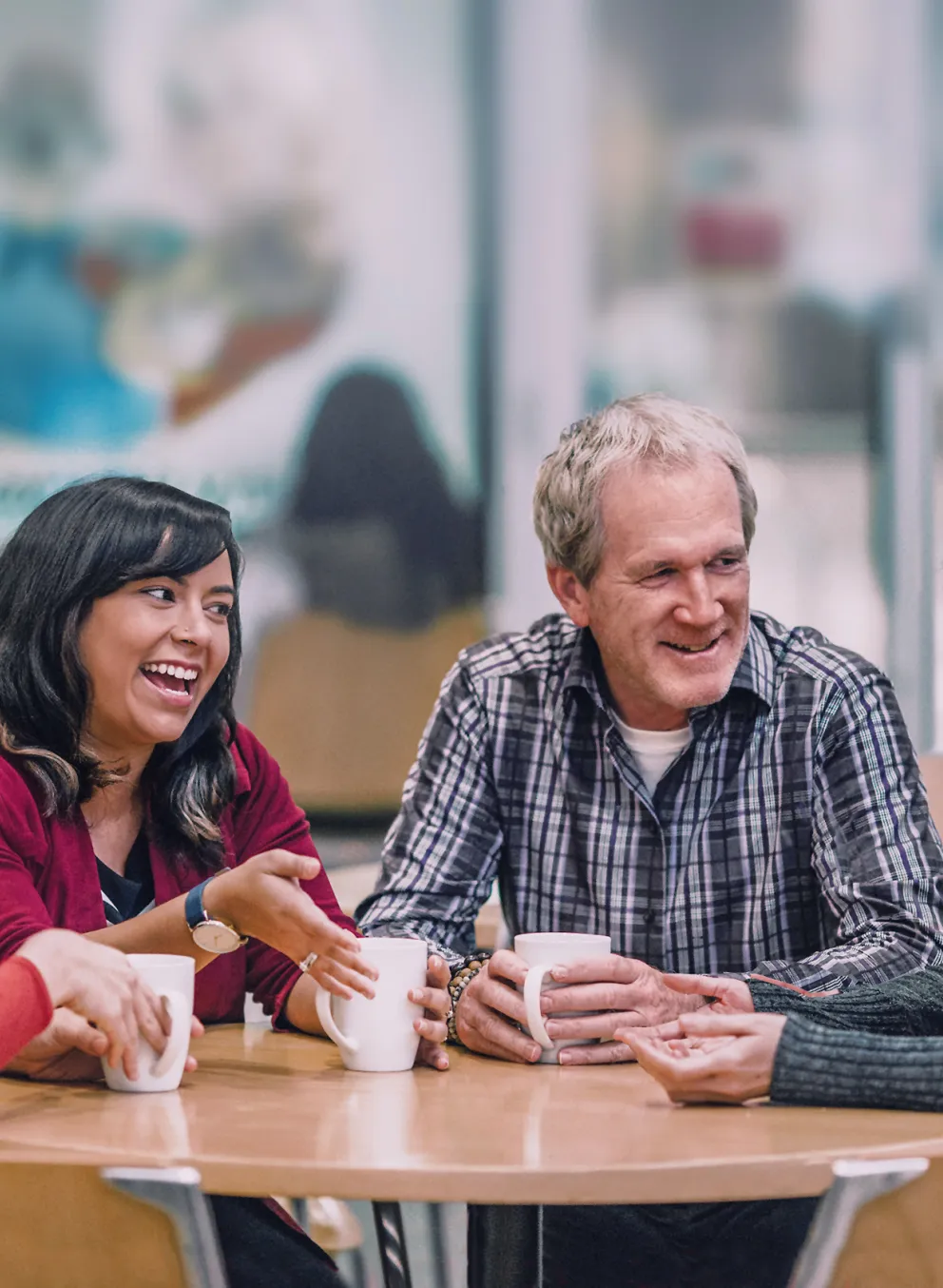 Group of people sitting together at a table and talking