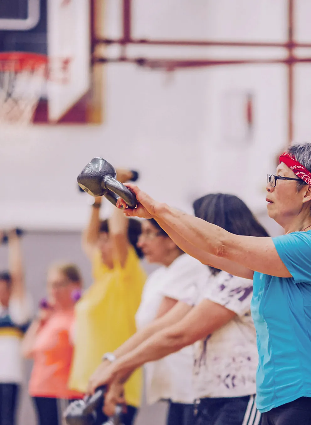 Group of women in an exercise class using weights