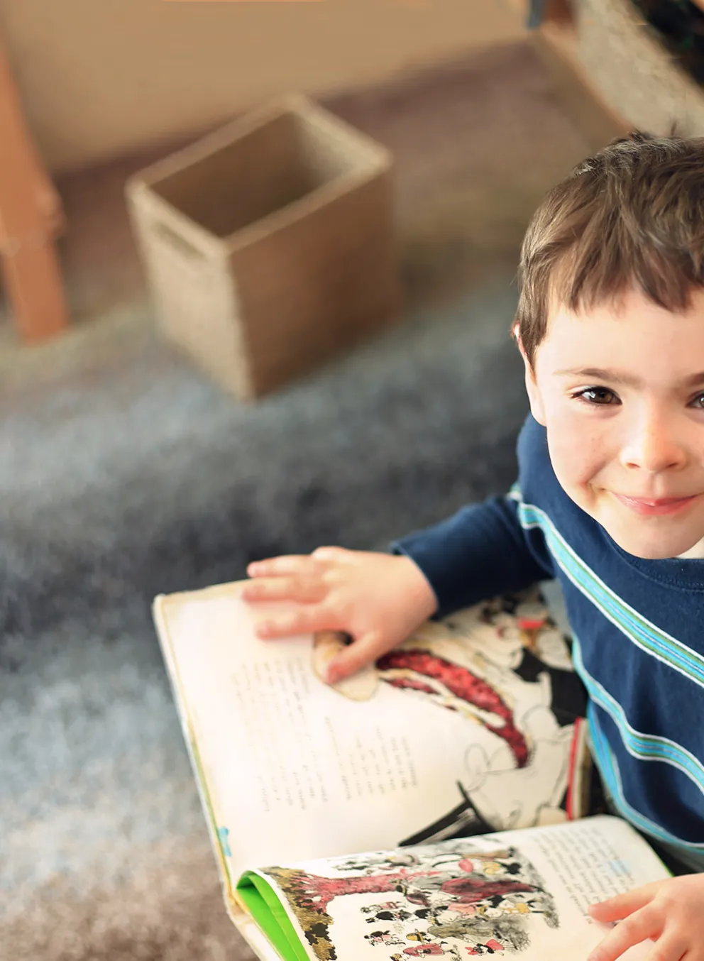 [Image] school aged boy sitting and reading a story