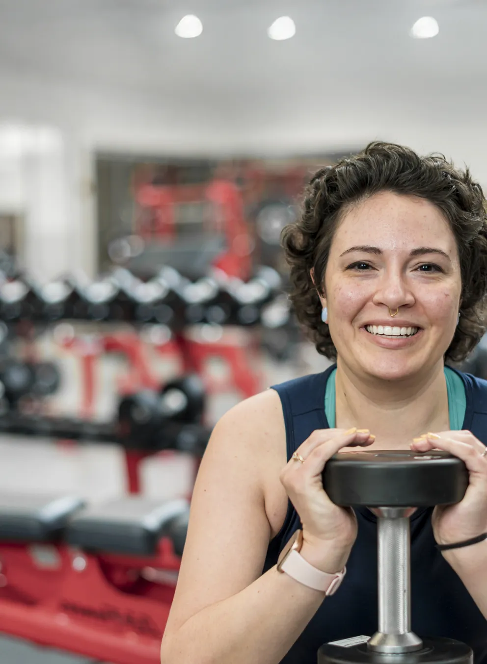 Woman goblet squatting a weight in fitness centre