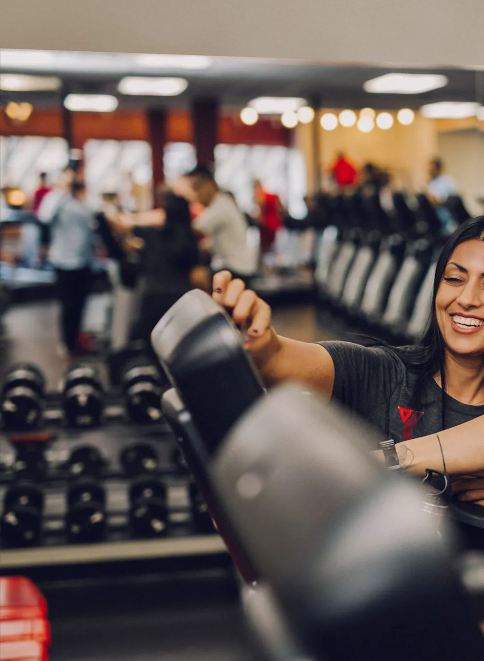 Staff showing member how to work cardio machine