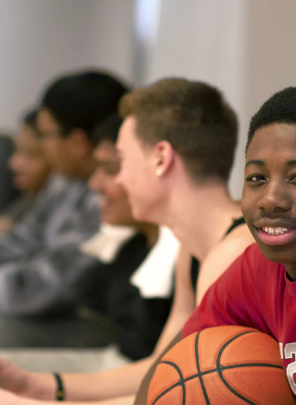 Boys with basketball siting on bench