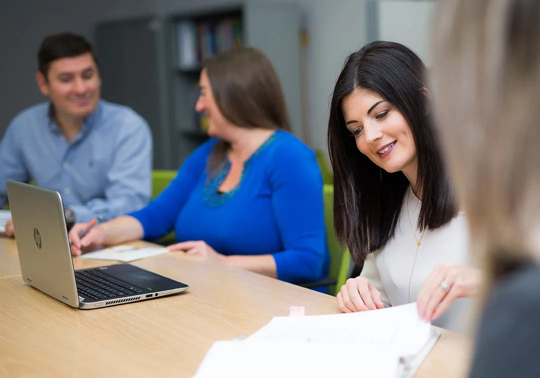 A Group of Four People Work on Business Plans