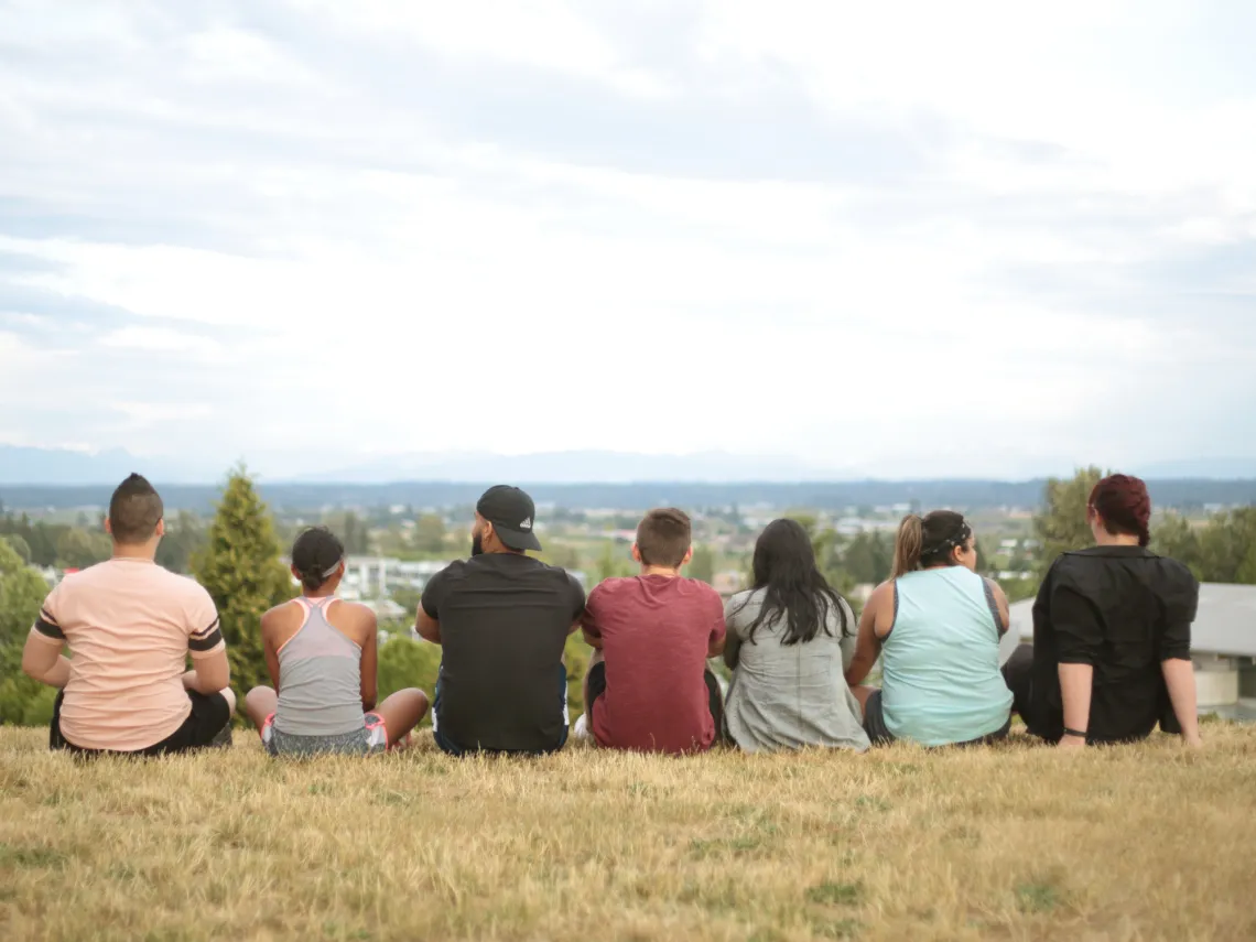 Young Adults Sitting and Looking at the Horizon