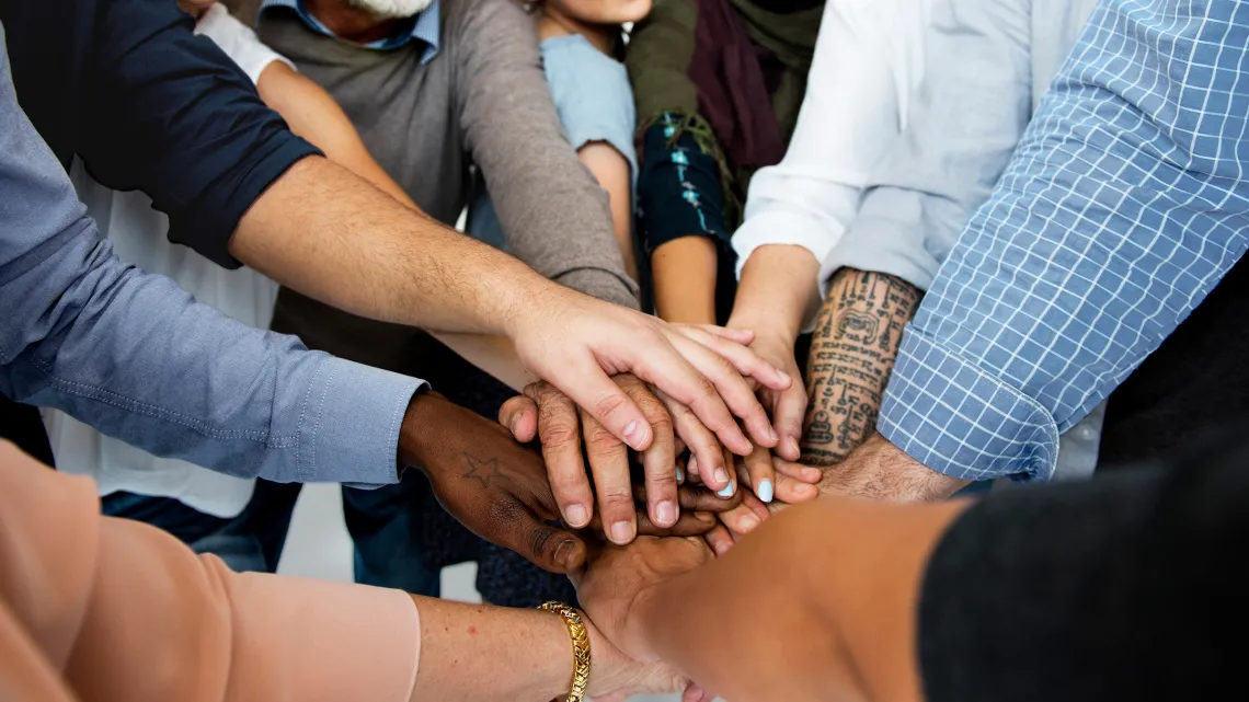 Circle of People Stacking Hands