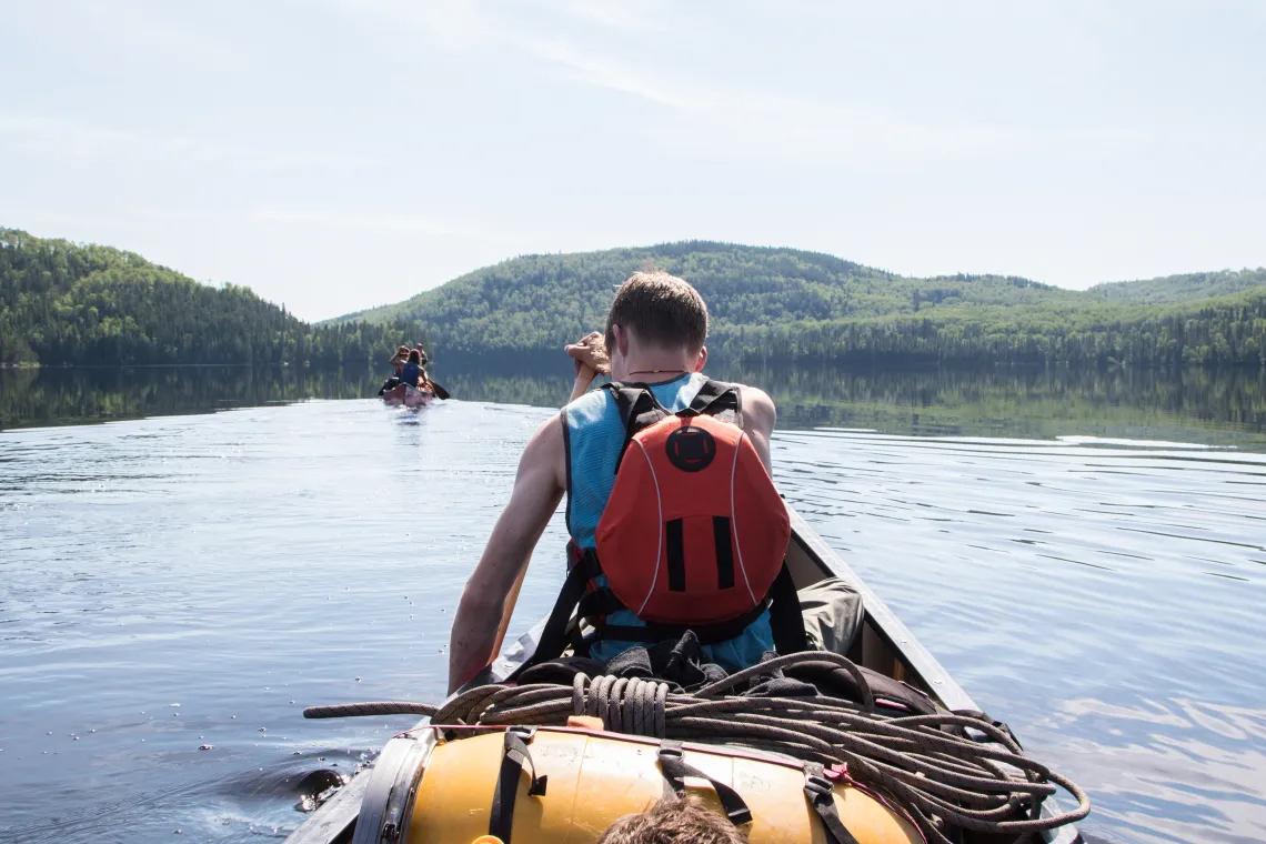 canoeist on open water looking from behind