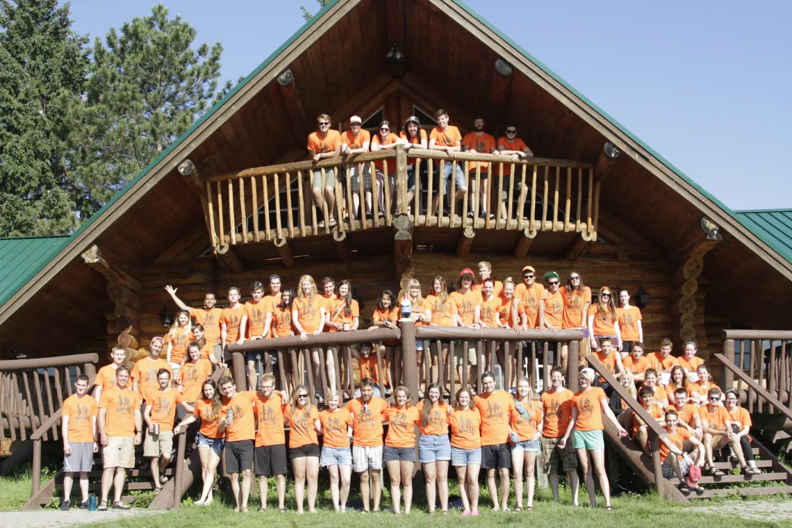 Image of large group of Counsellors in front of camp building