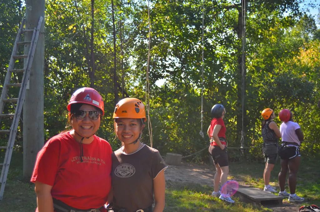 Smiling women doing the ropes course