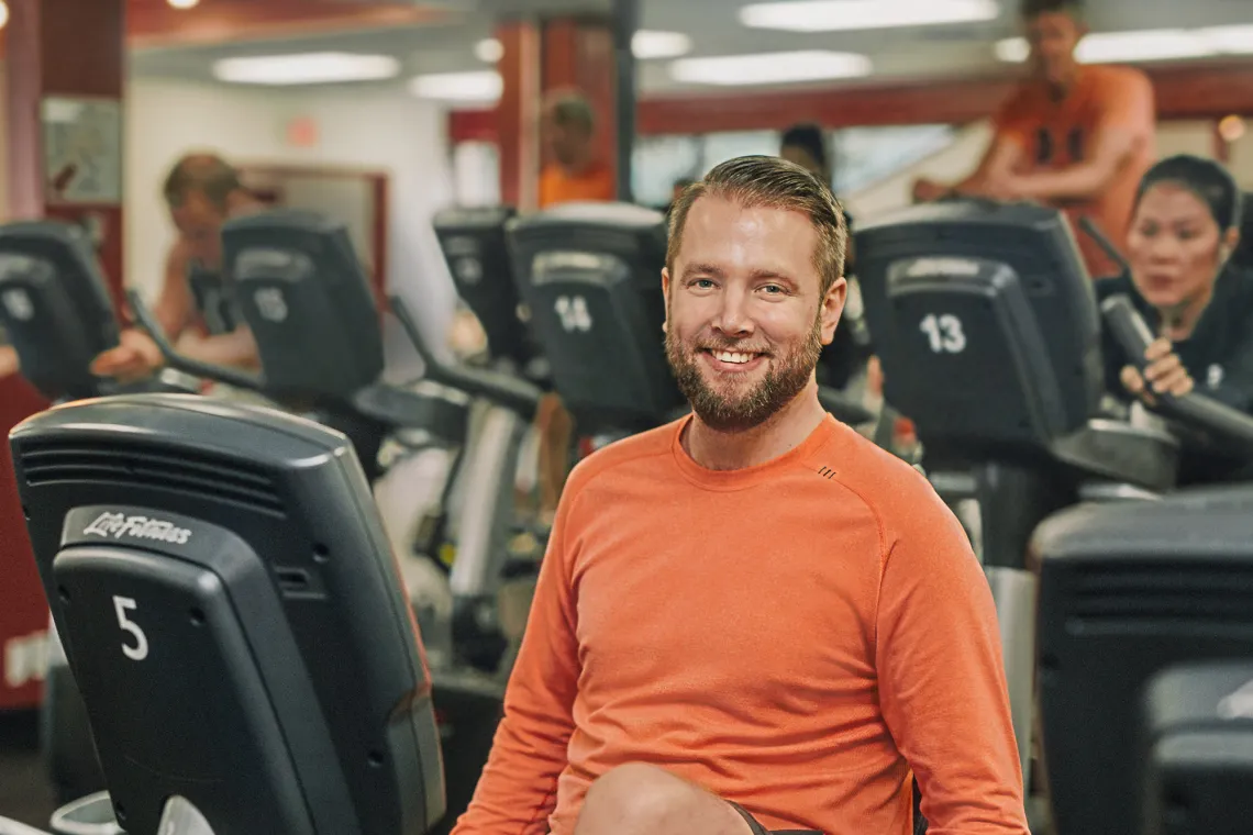 Smiling man sitting on a recumbant bike