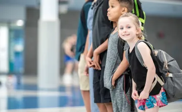 : A group of kids standing at the Y. 