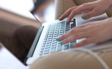 Fingers on a laptop keyboard